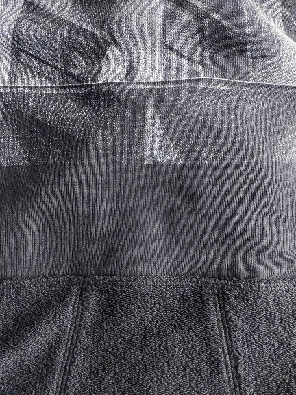 Close-up of a textured gray fabric with a high-quality screen print for long-lasting wear.